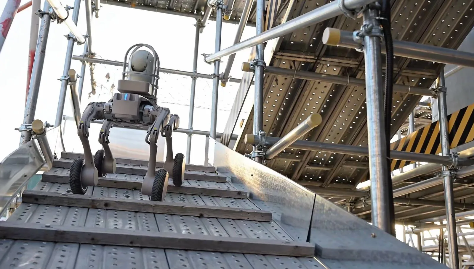 Wheeled legged robot with a pan-tilt camera on a steel platform in an industrial plant