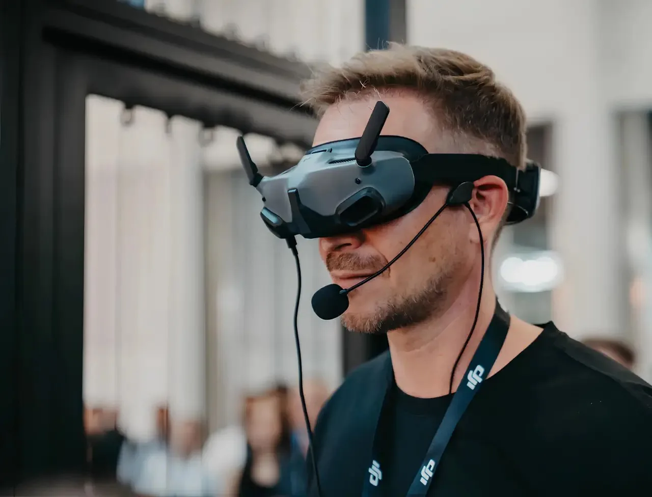 Pilot wearing FPV goggles and a headset