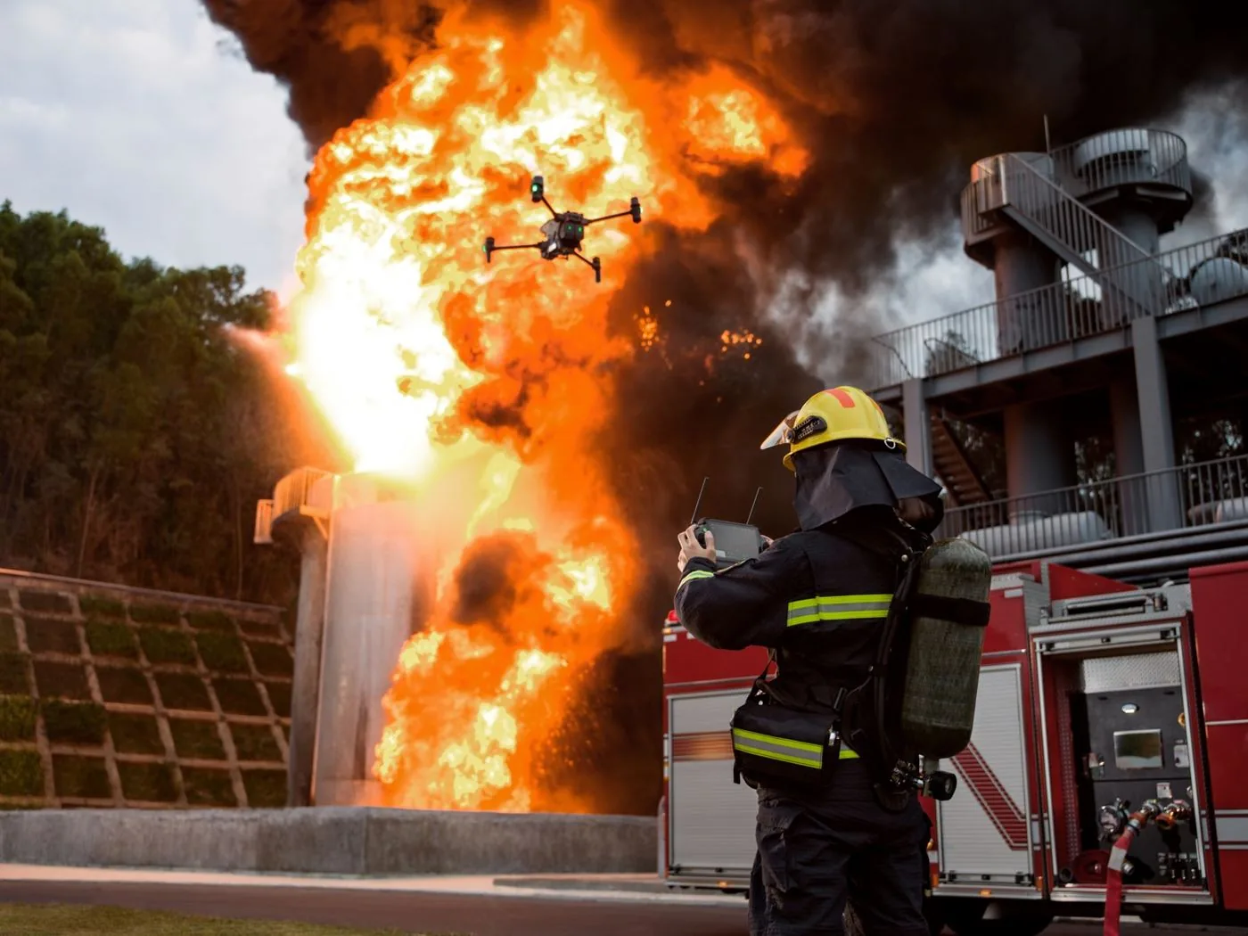 Firefighter flying a drone over a major fire