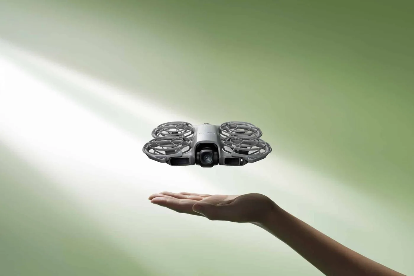 DJI Neo 2 with guarded propellers hovering above an open palm