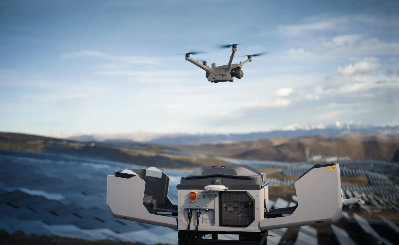 Drone launching from an open dock over a solar farm