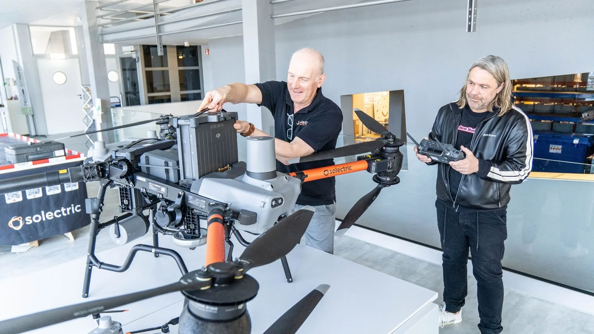 Olaf Kappler, Managing Partner of Solectric, showing a visitor a cargo drone