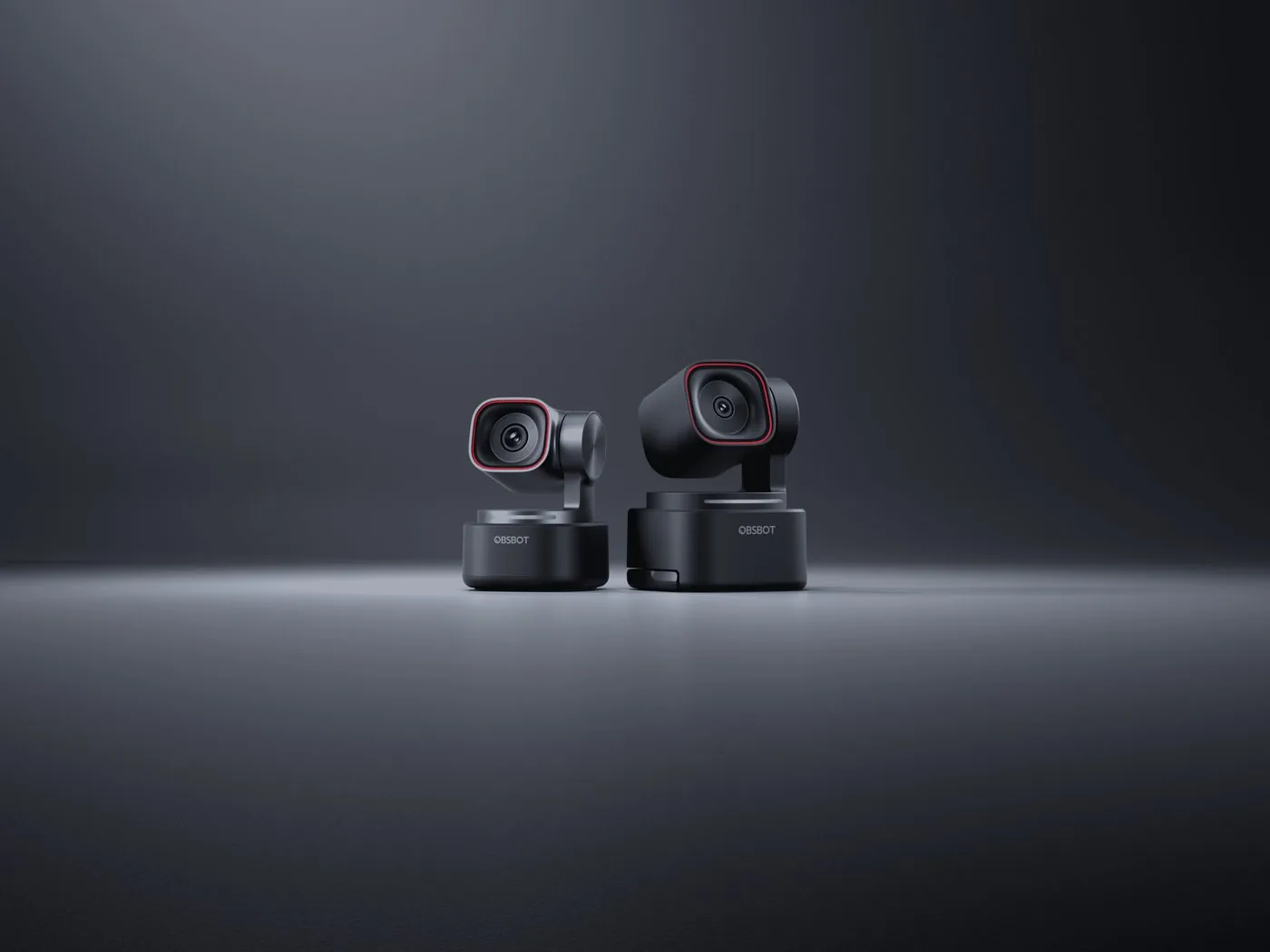 Two auto-tracking conference cameras against a dark background