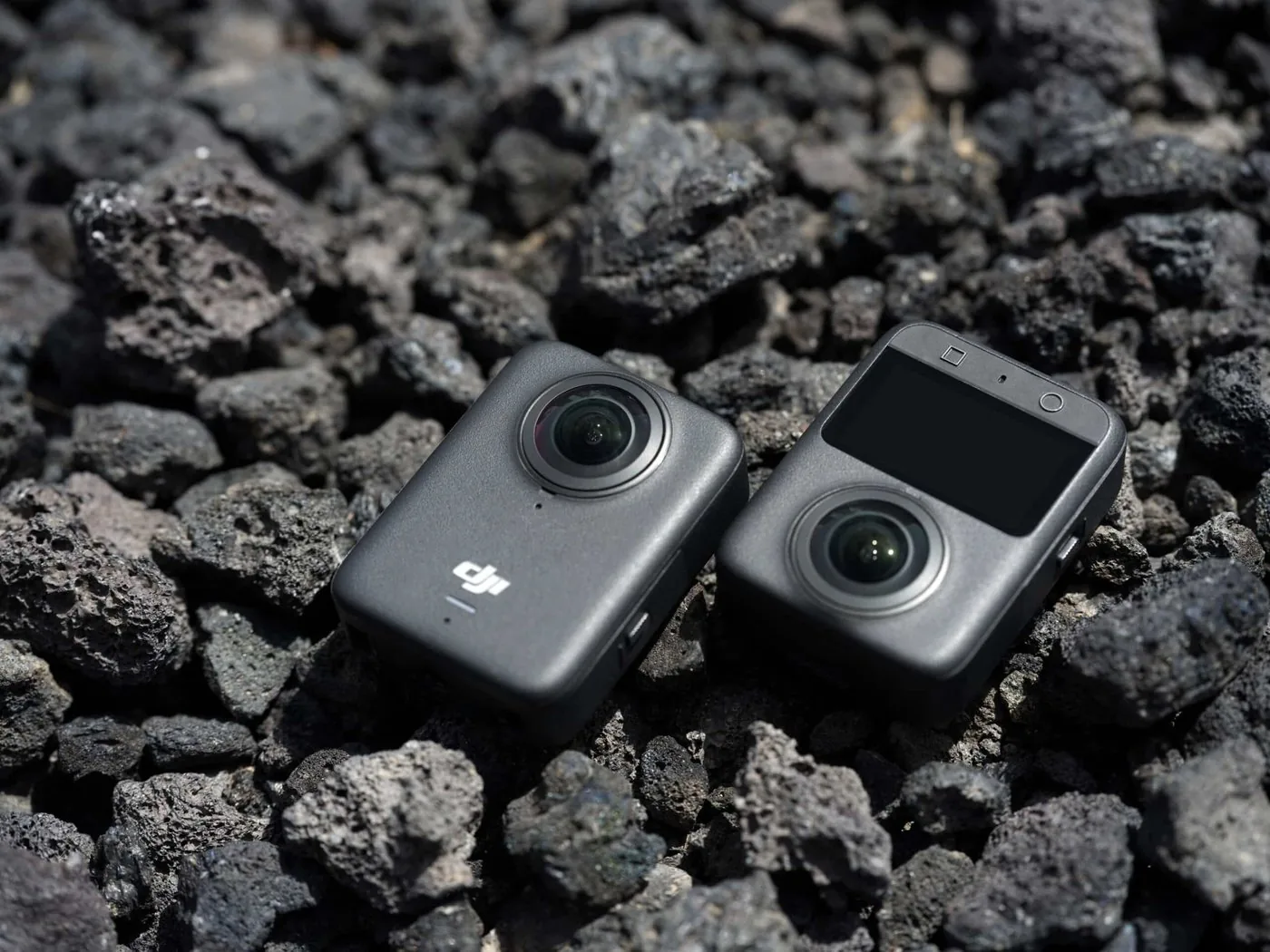 Two DJI Osmo 360 cameras on dark rock
